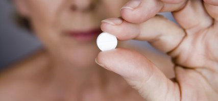 Woman holding pill